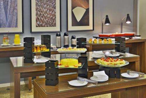 a buffet with many different types of food on display at Hotel Deville Curitiba in Curitiba