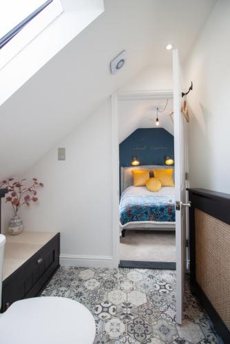 a bedroom with a bed and an open door at Poppyline Mews in Sheringham