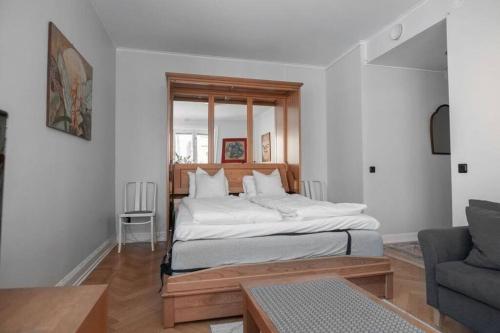 a bedroom with a large bed and a couch at Apartment in Södermalm 1-4 people 47 sqm in Stockholm
