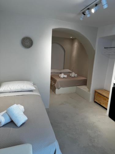 a bedroom with two beds in a room with an attic at White Sand Cave Suite in Ios Chora