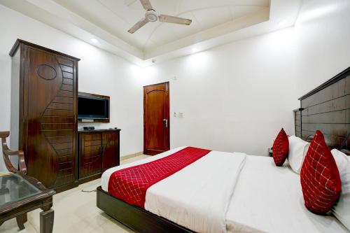 a bedroom with a large bed and a television at Hotel Legend International -Just a min walk from New Delhi Railway Station in New Delhi