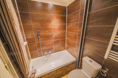 a bathroom with a toilet and a bath tub at Appart Casamozza Corsica in Lucciana
