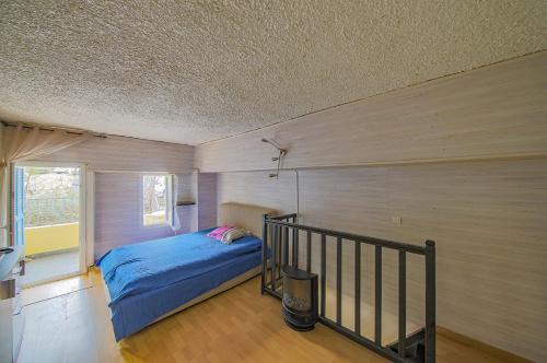 a bedroom with a bed in a room with a balcony at Appart Casamozza Corsica in Lucciana