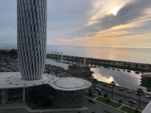 een uitzicht op een gebouw en een brug over het water bij Black Sea Vi Dari Apartments in Batoemi