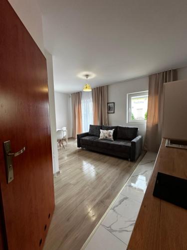 a living room with a couch and a table at Apartamenty Marina in Rowy