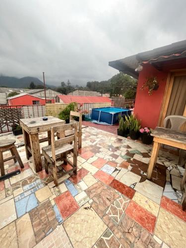 a patio with a table and benches on a patio at Jireh Antigua in Antigua Guatemala