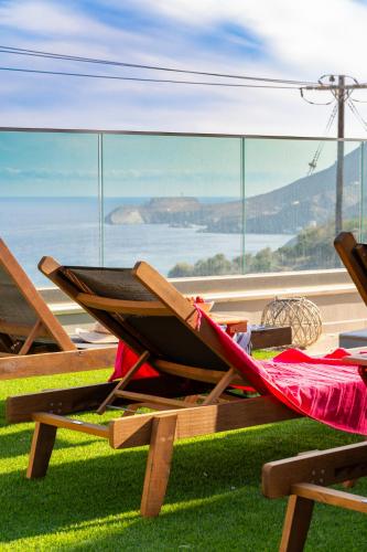 a hammock on a table with a view of the ocean at Evelyn Villa Crete in Tsoútsouros