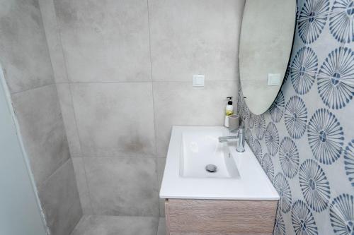 a bathroom with a sink and a mirror at Pteleo Apartments in Pteleós