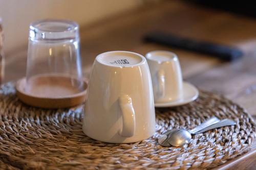 a table with a coffee cup and spoons on it at I Due Mondi Rooms in Portoferraio