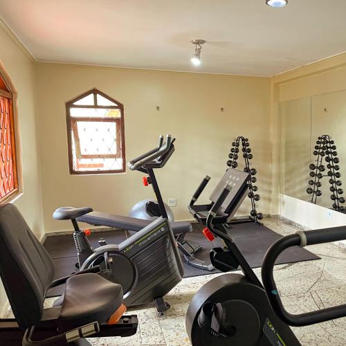 a gym with several exercise bikes in a room at Hotel Nacional Inn Campos do Jordão in Campos do Jordão