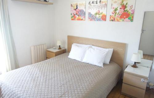 une chambre avec un lit avec des draps blancs et des oreillers dans l'établissement Appartement 2 pièces Port-Camargue - Le Grau-du-Roi, Plage Sud, au Grau-du-Roi