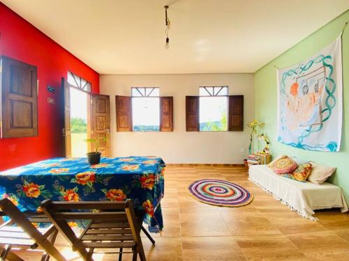 a living room with a table and a couch at Casa Bela Vista in Lençóis