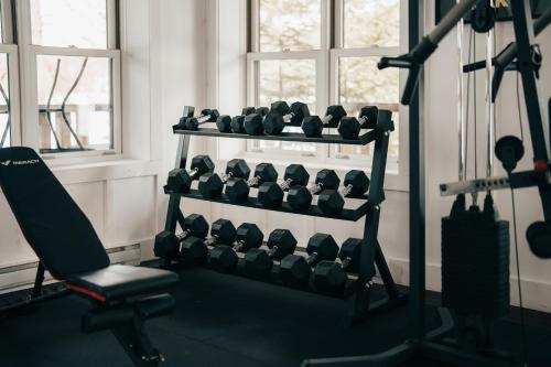 a gym with a rack of dumbbells at Lakefront, Mountain View - 1 Bedroom Resort Suite in Lac-Superieur