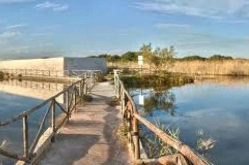 a bridge over a body of water with a fence at Blue Sea Apartment in Torre Canne