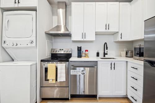 a kitchen with white cabinets and stainless steel appliances at The Garden Suite in London, On 1BR, 1B with free washer and dryer in London