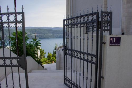 a black iron gate with a view of the water at Zvijezda Mora in Neum