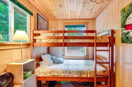 a bedroom with bunk beds in a tree house at Denmark Waterfront Cabin with Dock and Charcoal Grill! in Denmark