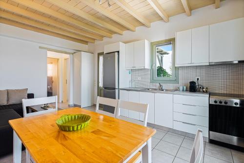 a kitchen and dining room with a wooden table at Lagadia Village in Andiparos