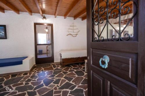 a room with a wooden door and a room with a doorway at Cottage On The Wave With Amazing View in Paralia Kallonis