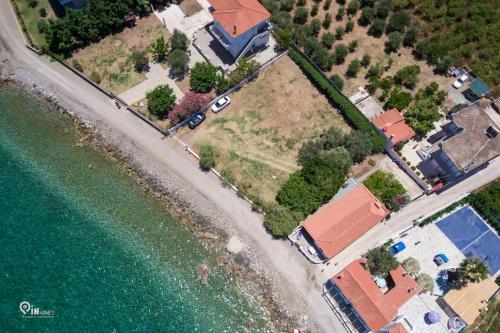 an aerial view of a house next to the water at Cottage On The Wave With Amazing View in Paralia Kallonis