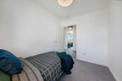 a bedroom with a bed and a hallway at Clapham Wynd House - Grampian Lettings Ltd in Arbroath