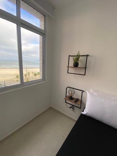 Postel nebo postele na pokoji v ubytování Apartamento Frente à Praia Santos II