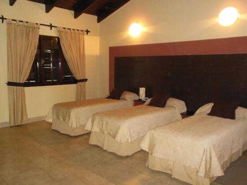 a hotel room with two beds and a window at Hotel Aybal in Salta