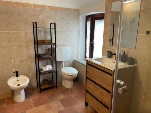 a bathroom with a toilet and a sink at Cascina Mabette in Farigliano