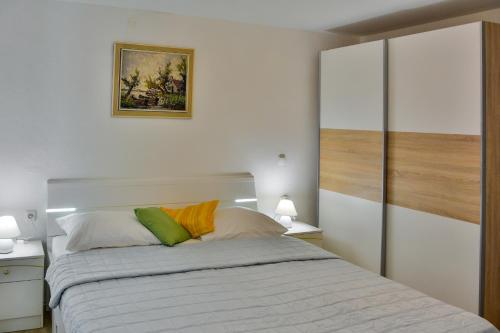 a bedroom with a large bed with two lamps at Apartment Bela in Senj