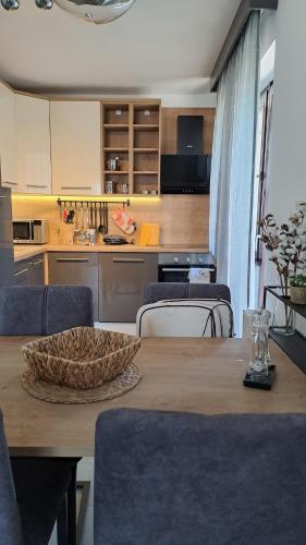 a kitchen and dining room with a wooden table at Apartman NAR Murter in Murter