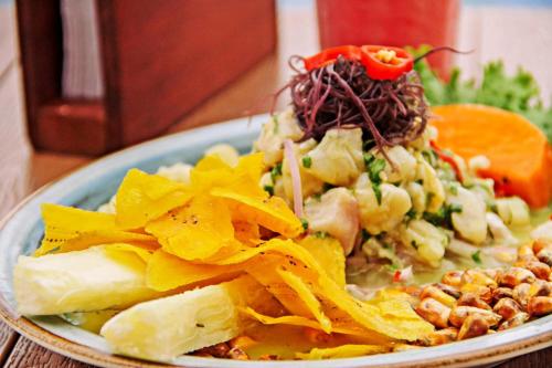 a plate of food with a salad on a table at Hotel de Turistas Iquitos in Iquitos