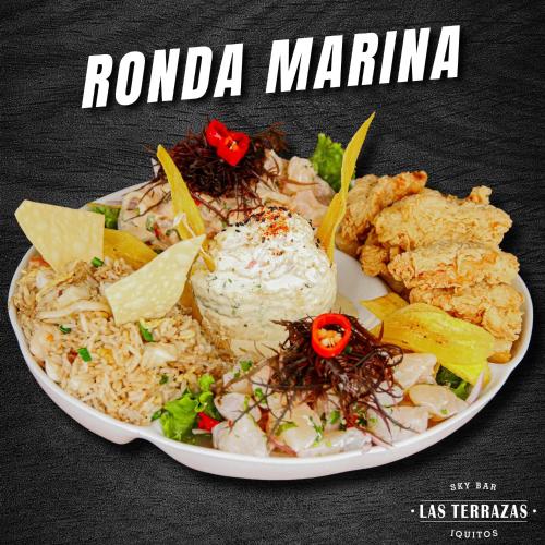 a plate of food with rice and other foods at Hotel de Turistas Iquitos in Iquitos
