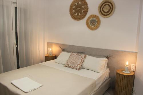 a bedroom with a bed with two candles on it at House Fedra in Potos