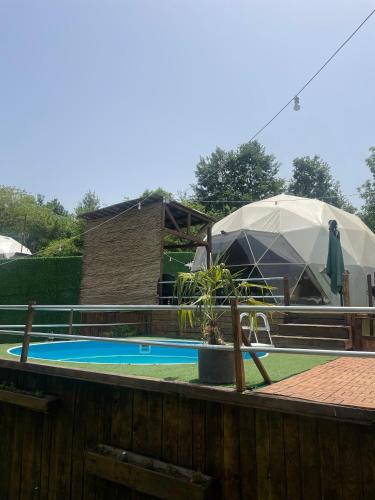 a swimming pool with a tent in a yard at Bellatrix dome in Sapanca