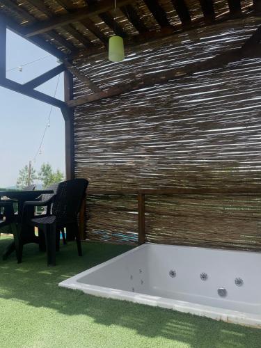 a bath tub in a room with a table and chairs at Bellatrix dome in Sapanca