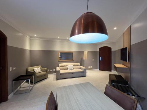 a living room with a table and a couch at Flat no Gonzaga - Santos in Santos