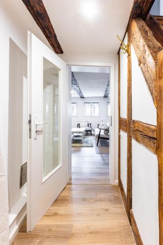 an open door leading into a living room with wood floors at Ferienwohnung Zuckerschnute in Quedlinburg