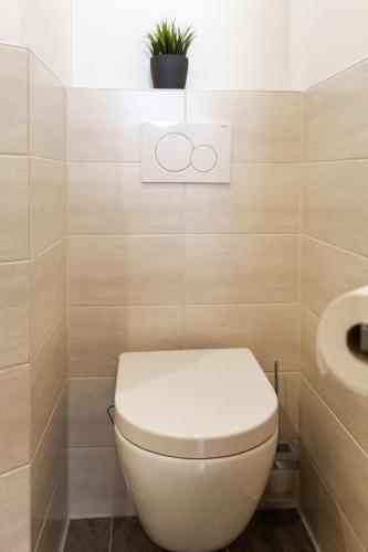 a bathroom with a toilet and a sink at Pension Märkl Augsburg in Augsburg