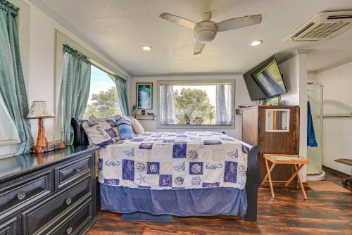 a bedroom with a bed and a dresser and a window at Waterfront Perry Home Rooftop Deck, Pets Welcome! in Perry
