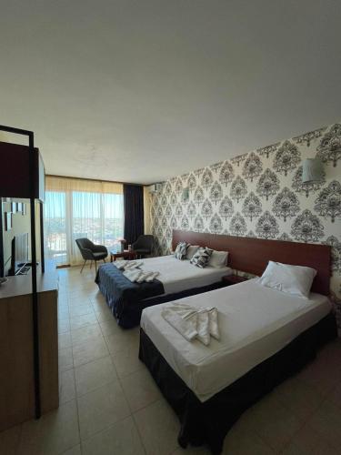 a hotel room with two beds and a television at Moreno in Sozopol