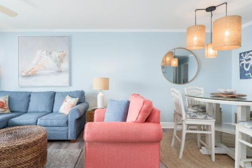 a living room with a couch and a table at Sands III #1C - Toes In the Water in Carolina Beach