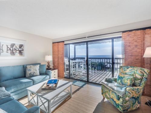 a living room with a couch and a table at Sea Colony 21B in Carolina Beach