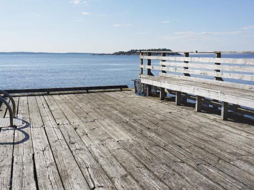 a wooden dock with a bench on the water at 5 person holiday home in STRÖMSTAD in Strömstad