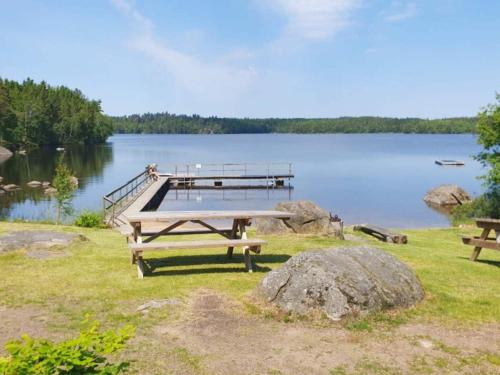 a picnic table on the shore of a lake at 4 star holiday home in KARLSKRONA in Karlskrona