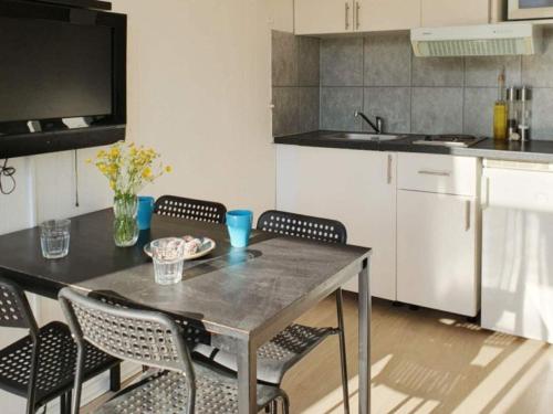 a kitchen with a table and chairs in a kitchen at 4 star holiday home in KARLSKRONA in Karlskrona