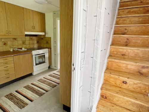 a kitchen with a staircase in the middle of a room at 4 person holiday home in ASARUM in Asarum