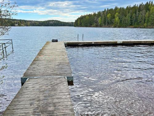 a wooden dock in the middle of a lake at 9 person holiday home in HUDDINGE in Huddinge