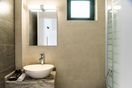 a bathroom with a sink and a mirror at Celestial Studios in Kavos