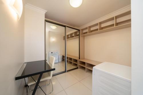 a walk in closet with a desk and a table at #1 Luxury Jacuzzi Penthouse In Quiet Centre Riga in Rīga