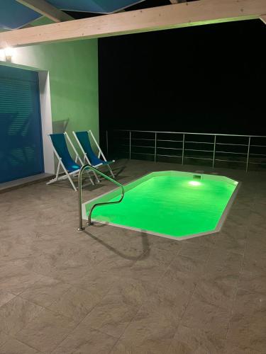 a room with two chairs and a green floor at VILLES RANIA in Karpathos Town